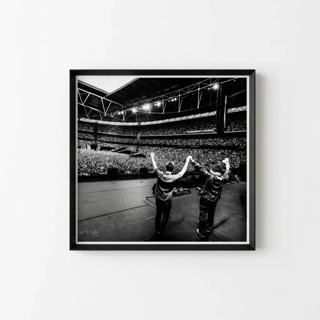 A black and white concert photograph in a black frame with a white mount